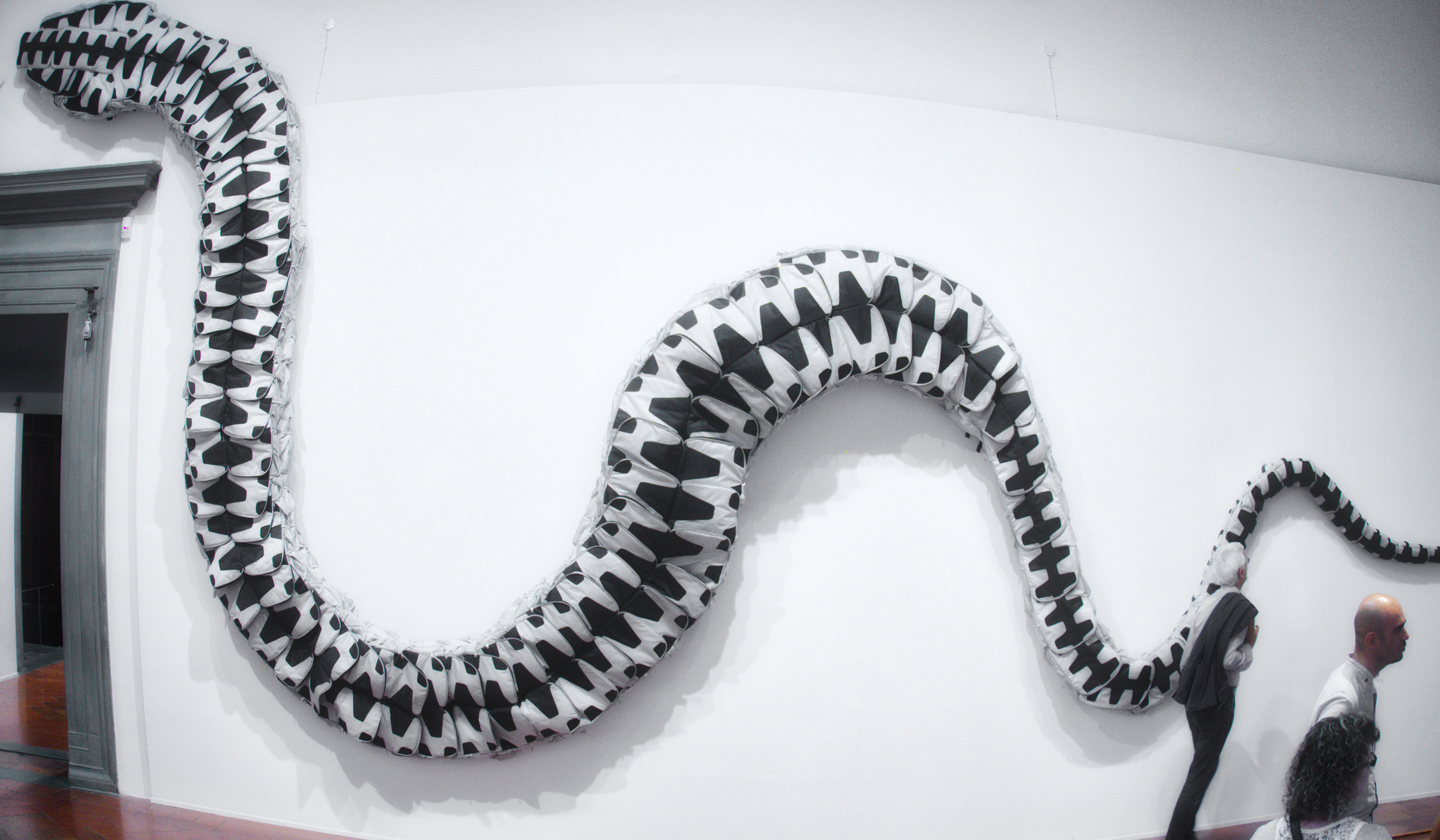 Gran serpiente hecha con portafolios de diferentes tamaños.